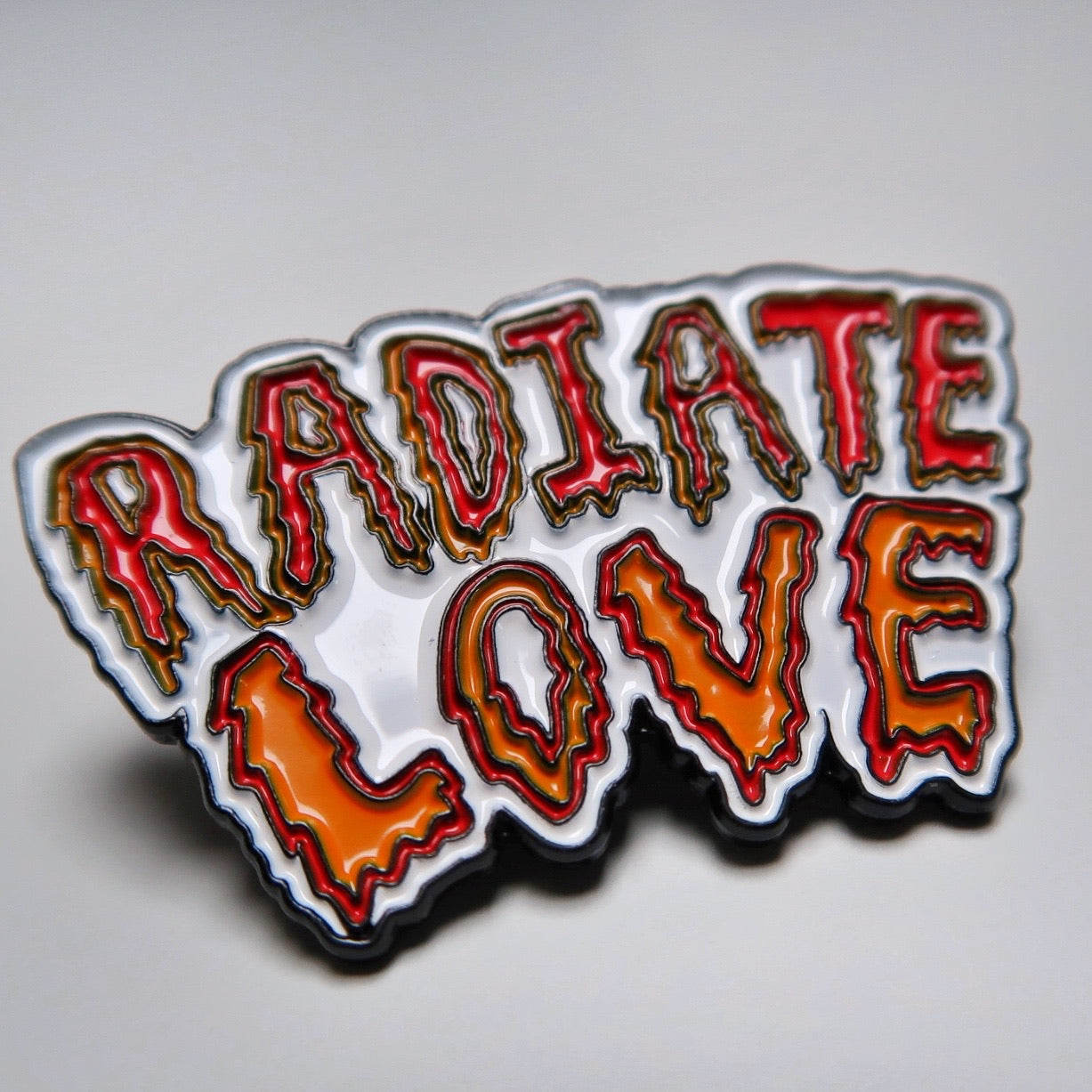 radiate love enamel pin badge