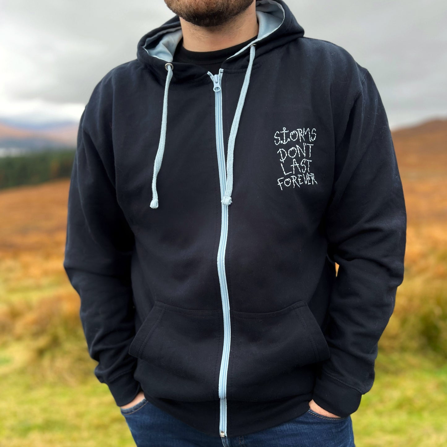 storms don’t last forever embroidered zip-up hoodie