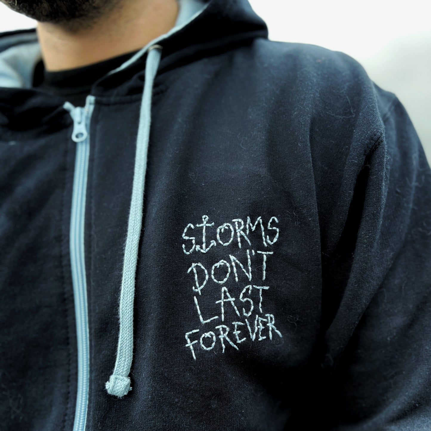 storms don’t last forever embroidered zip-up hoodie