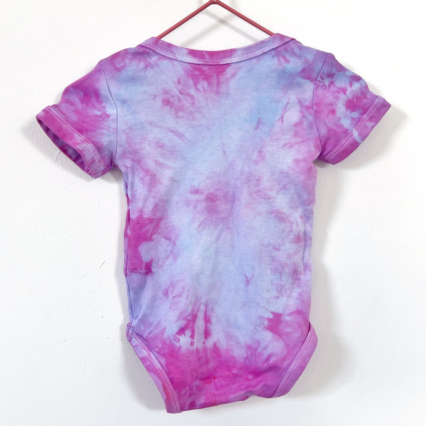 hate is taught tie dye baby bodysuit
