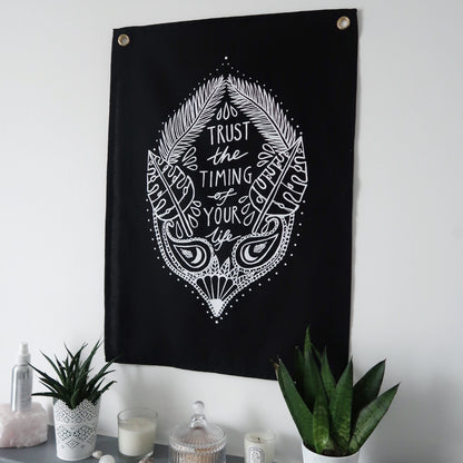 trust the timing of your life wall hanging - black